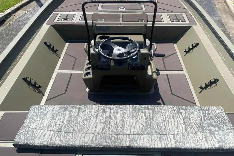 Slide: The Image of 2026 Tracker Grizzly 2072 CC boat interior with steering console and camouflage seating. - 4