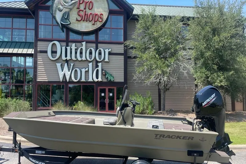 Slide: The Image of 2026 Tracker Grizzly 2072 CC boat outside Outdoor World store. - 5