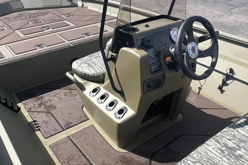 Slide: The Image of Interior view of 2026 Tracker Grizzly 2072 CC boat with steering console and seating. - 6