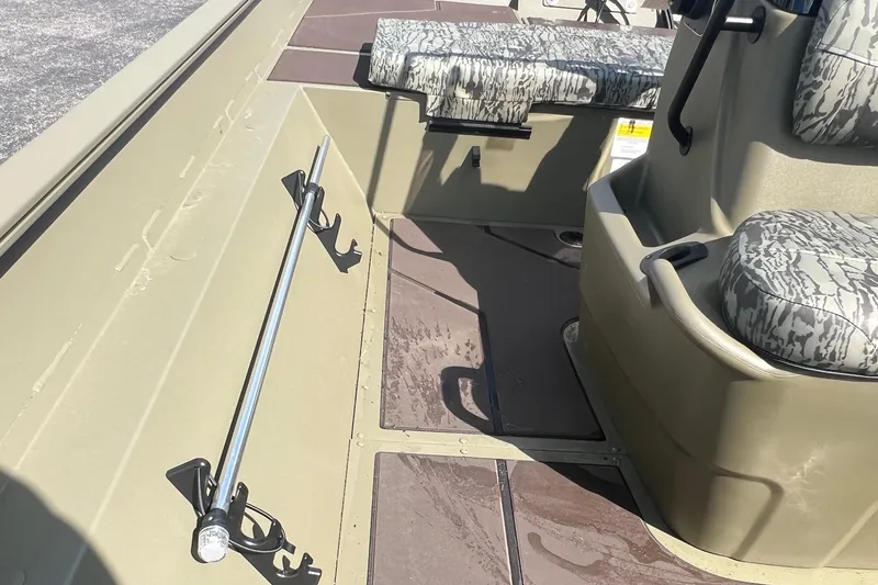 Slide: The Image of 2026 Tracker Grizzly 2072 CC boat interior with camo seats and rod holder. - 7