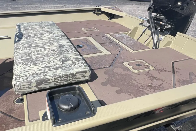 Slide: The Image of 2026 Tracker Grizzly 2072 CC boat interior with camo seating and storage compartments. - 8