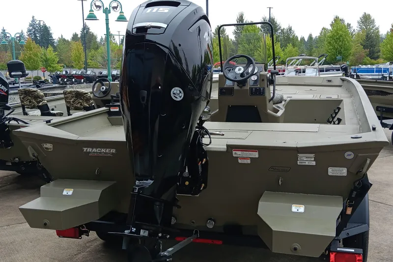 Slide: The Image of 2026 Tracker Grizzly 2072 CC boat with powerful outboard motor, parked outdoors. - 4