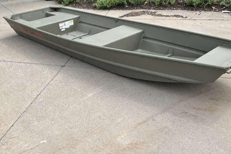 The Image of 2026 Tracker Grizzly 14 Jon boat on concrete surface, showcasing its sturdy design. - 0