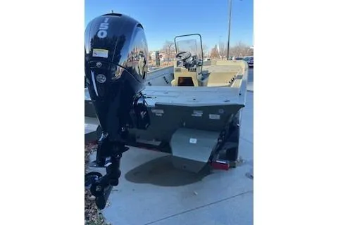Slide: The Image of 2026 Tracker Grizzly 2072 CC boat with outboard motor, parked on pavement. - 38