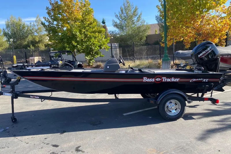 The Image of 2026 Tracker Bass Tracker Classic XL boat on trailer, parked outdoors. - 0