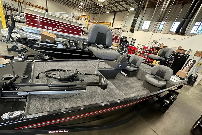 Slide: The Image of 2026 Tracker Bass Tracker Classic XL fishing boat in a showroom, featuring multiple seats and equipment. - 4
