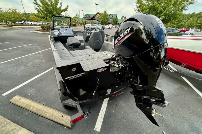 Slide: The Image of 2026 Tracker Pro Guide V-175 Combo boat with Mercury outboard in parking lot. - 3
