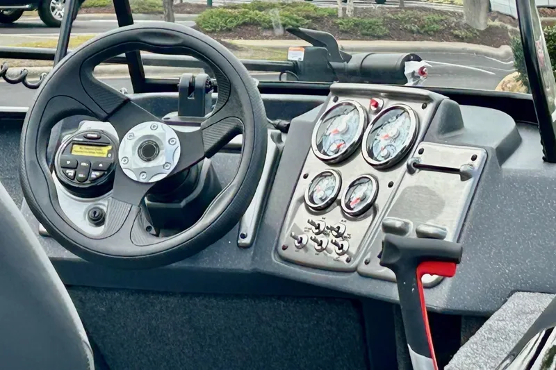 Slide: The Image of 2026 Tracker Pro Guide V-175 Combo boat dashboard with steering wheel and instrument panel. - 4
