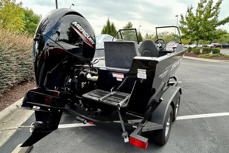 Slide: The Image of 2026 Tracker Pro Guide V-175 Combo boat with Mercury engine in parking lot. - 5