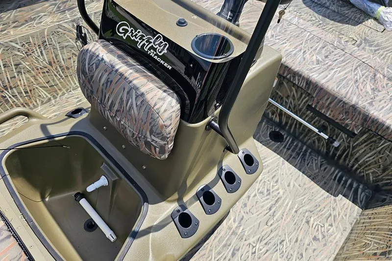Slide: The Image of 2026 Tracker Grizzly 2072 CC boat interior with camo seating and storage compartments. - 11