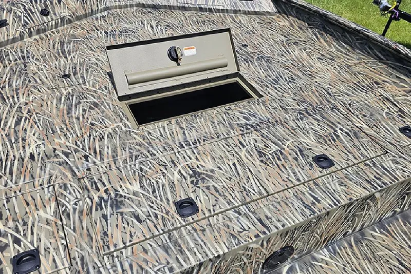 Slide: The Image of 2026 Tracker Grizzly 2072 CC boat with camo pattern and open storage compartment. - 14