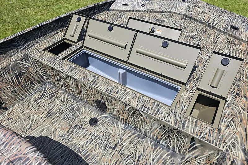 Slide: The Image of 2026 Tracker Grizzly 2072 CC boat interior with camo design and storage compartments. - 15