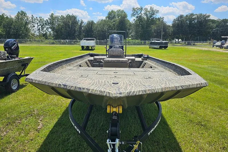 Slide: The Image of 2026 Tracker Grizzly 2072 CC boat on grassy field, showcasing camo design and spacious deck. - 4