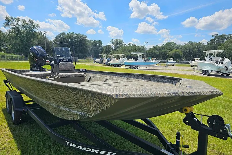 Slide: The Image of 2026 Tracker Grizzly 2072 CC boat on trailer, parked on grass under blue sky. - 5