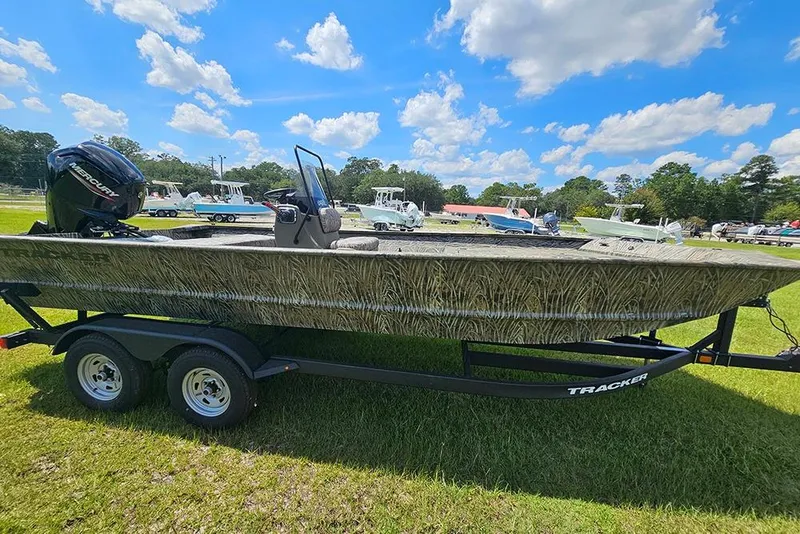 Slide: The Image of 2026 Tracker Grizzly 2072 CC boat on trailer, grassy field, blue sky background. - 6