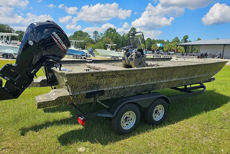 Slide: The Image of 2026 Tracker Grizzly 2072 CC boat with Mercury engine on trailer, parked on grass. - 7