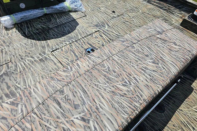 Slide: The Image of 2026 Tracker Grizzly 2072 CC boat interior with camouflage pattern seating and deck. - 8