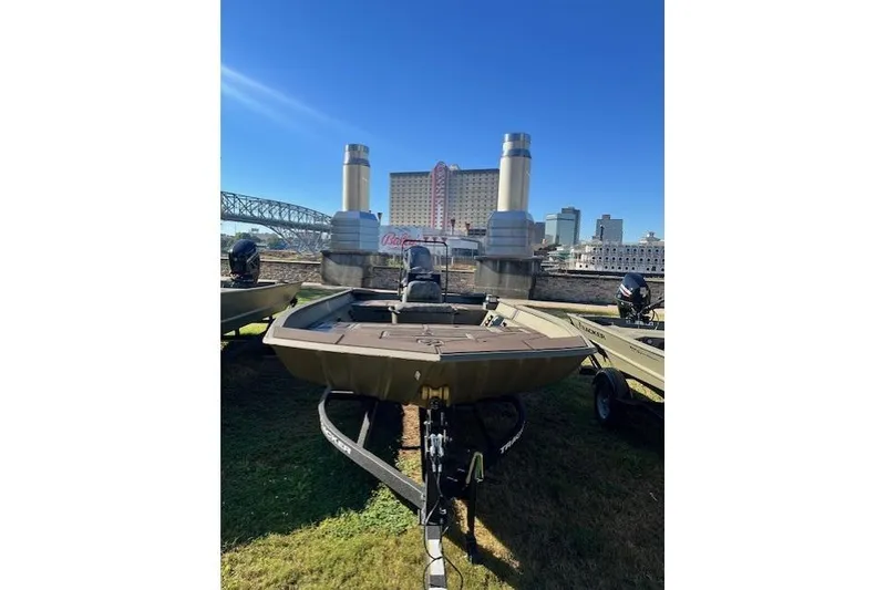 Slide: The Image of 2026 Tracker Grizzly 2072 CC boat on trailer, urban backdrop, clear sky. - 37