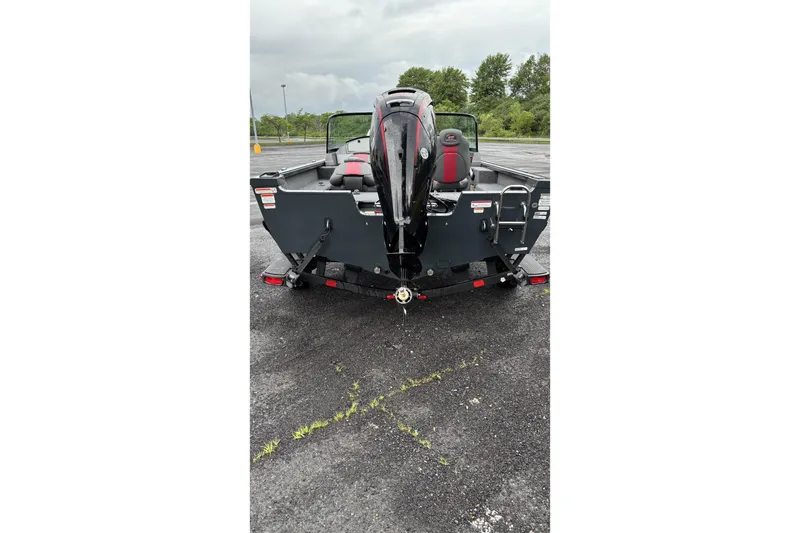 Slide: The Image of 2025 Ranger VS1682SC Angler boat, rear view, parked on asphalt with overcast sky. - 1