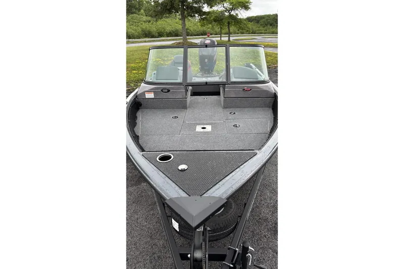 Slide: The Image of 2025 Ranger VS1682SC Angler boat with spacious deck and windshield, parked outdoors. - 2