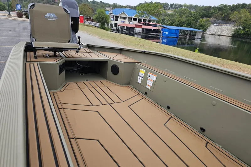 Slide: The Image of 2026 Tracker Grizzly 1650 T Prairie Wings Edition boat interior with seating and storage. - 8