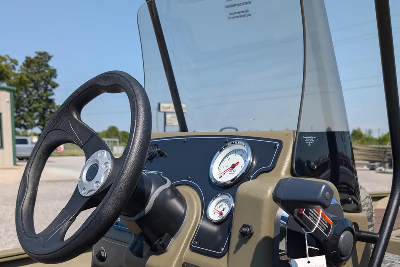 Slide: The Image of Steering console of 2026 Tracker Grizzly 1860 CC boat with gauges and controls. - 4