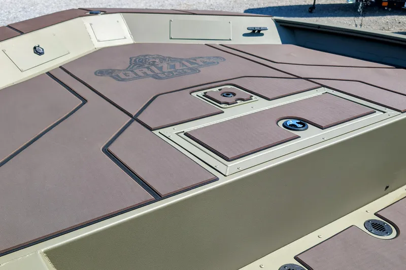 Slide: The Image of 2026 Tracker Grizzly 1860 CC boat deck with storage compartments and Grizzly logo. - 5