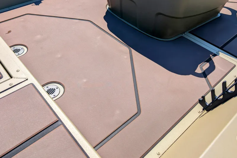 Slide: The Image of 2026 Tracker Grizzly 1860 CC boat deck with drainage features and storage compartments. - 6