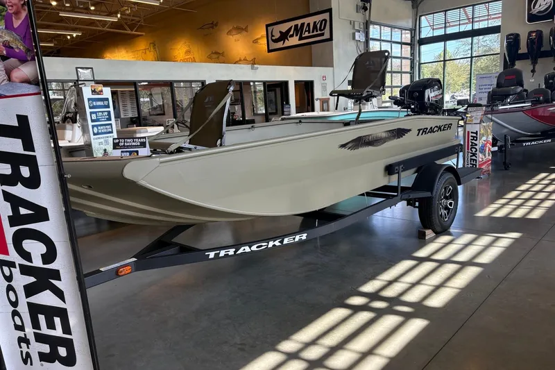 The Image of 2026 Tracker Grizzly 1650 T Prairie Wings Edition boat displayed in showroom. - 0