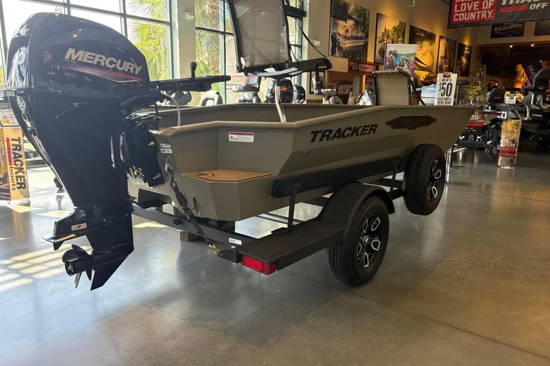 Slide: The Image of 2026 Tracker Grizzly 1650 T Prairie Wings Edition boat with Mercury engine in showroom. - 2