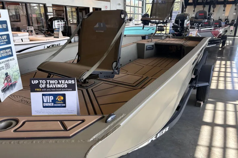 Slide: The Image of 2026 Tracker Grizzly 1650 T Prairie Wings Edition boat displayed in showroom with promotional offer. - 3