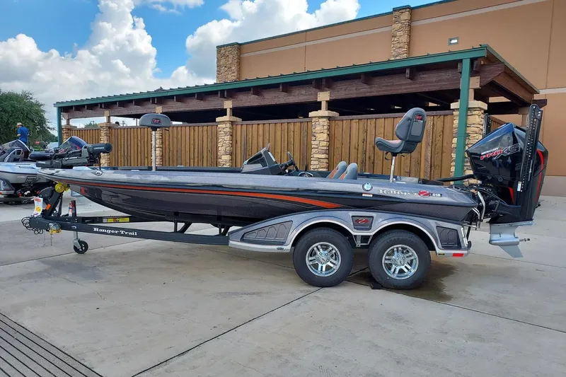 Slide: The Image of 2024 Ranger Z519 Ranger Cup Equipped boat on trailer, parked outdoors. - 0