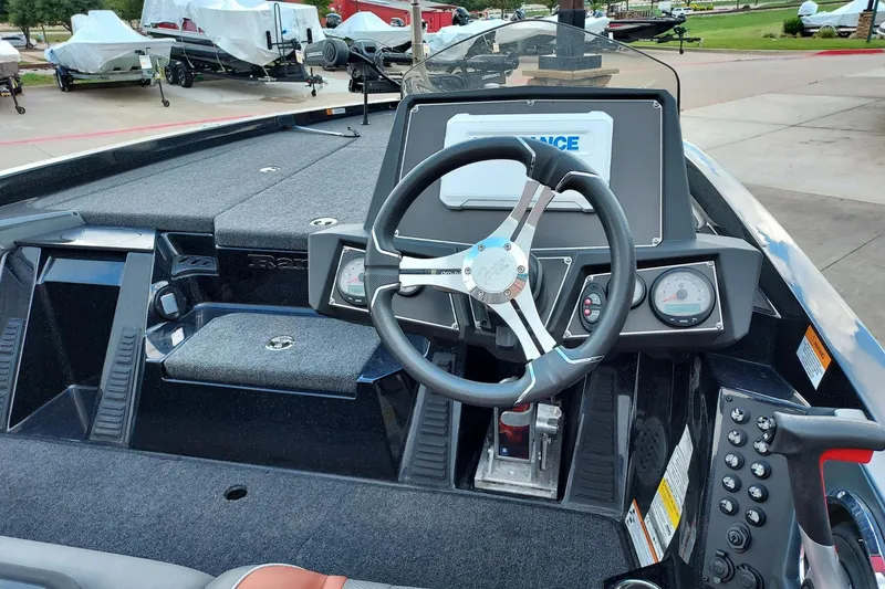 Slide: The Image of 2024 Ranger Z519 Ranger Cup Equipped boat dashboard with steering wheel and controls. - 2