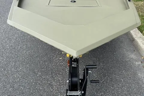 Slide: The Image of 2026 Tracker Grizzly 1648 Utility boat on trailer, parked on asphalt. - 6