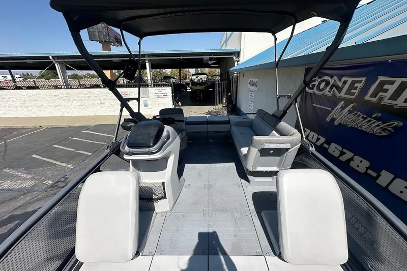Slide: The Image of 2024 Sea-Doo Switch Sport 18 pontoon boat interior with seating and canopy. - 11