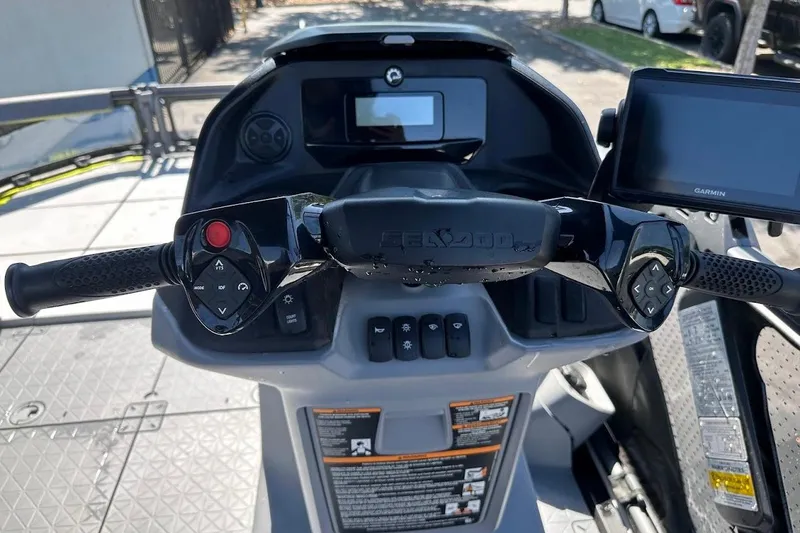 Slide: The Image of 2024 Sea-Doo Switch Sport 18 dashboard with controls and Garmin display. - 19