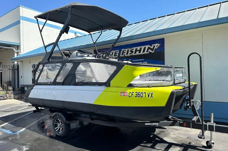 Slide: The Image of 2024 Sea-Doo Switch Sport 18 on trailer, parked outside a building. - 2