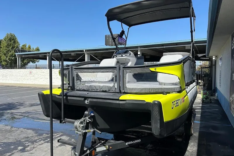 Slide: The Image of 2024 Sea-Doo Switch Sport 18 pontoon boat on trailer in parking lot. - 5