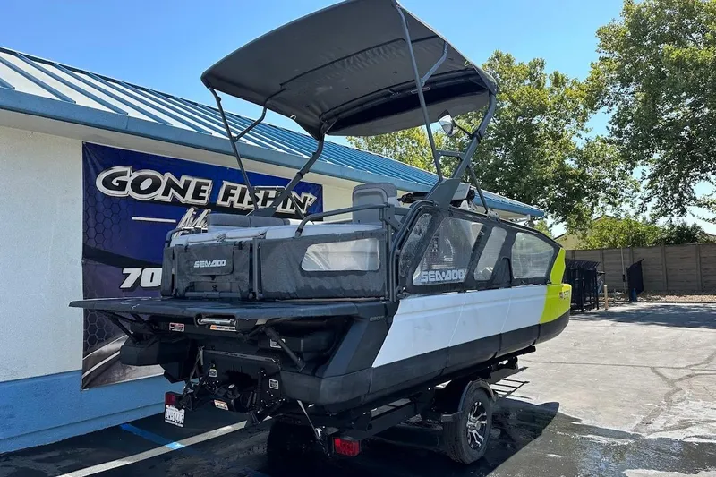 Slide: The Image of 2024 Sea-Doo Switch Sport 18 pontoon boat with canopy, parked outdoors. - 7
