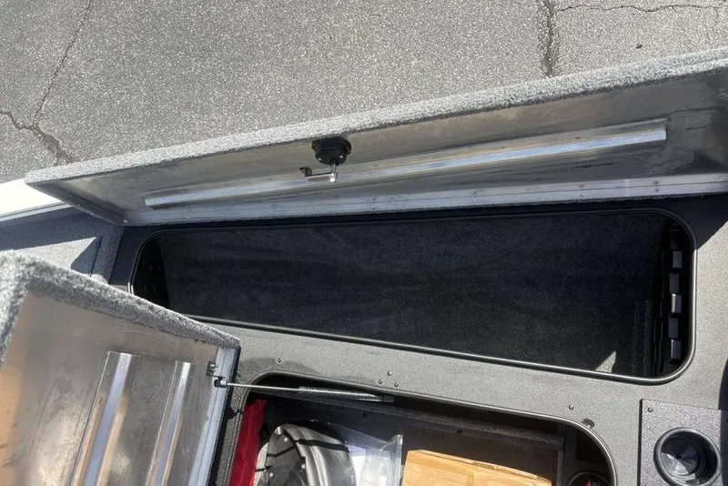 Slide: The Image of Open storage compartment on 2026 Tracker Pro Team 190 TX boat. - 11