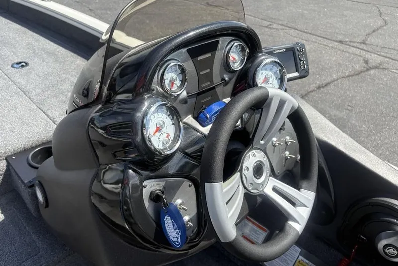 Slide: The Image of 2026 Tracker Pro Team 190 TX boat dashboard with steering wheel and gauges. - 18