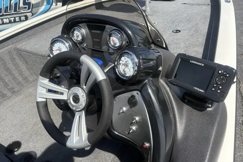Slide: The Image of 2026 Tracker Pro Team 190 TX boat dashboard with steering wheel and Lowrance fishfinder. - 19