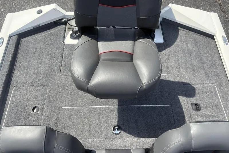 Slide: The Image of 2026 Tracker Pro Team 190 TX boat interior with gray seating and carpeted flooring. - 22