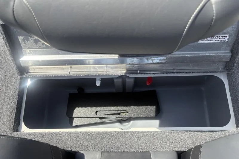 Slide: The Image of Storage compartment in 2026 Tracker Pro Team 190 TX boat, featuring carpeted interior. - 27