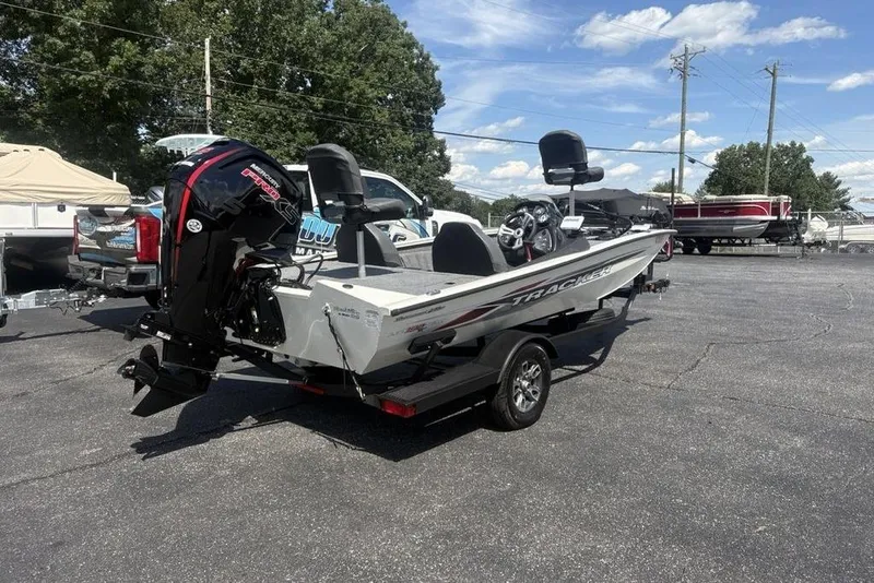 Slide: The Image of 2026 Tracker Pro Team 190 TX boat on trailer, parked outdoors under clear sky. - 5