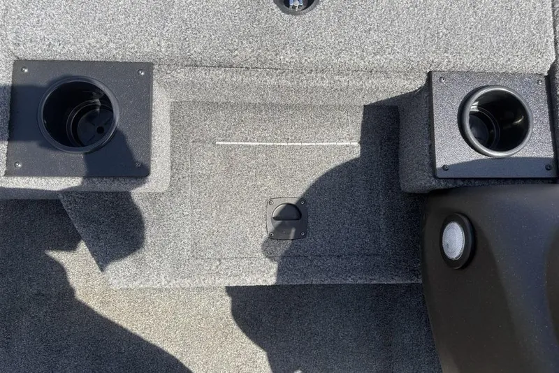 Slide: The Image of 2026 Tracker Pro Team 190 TX boat interior with cup holders and carpeted flooring. - 7