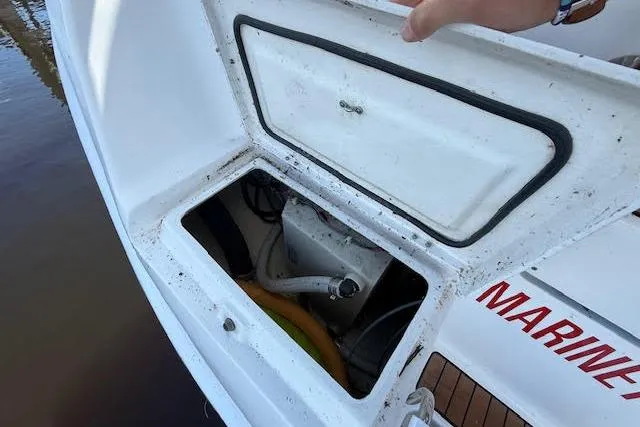 Slide: The Image of Open storage compartment on a 2005 Hunter 38 boat, showing interior equipment. - 11