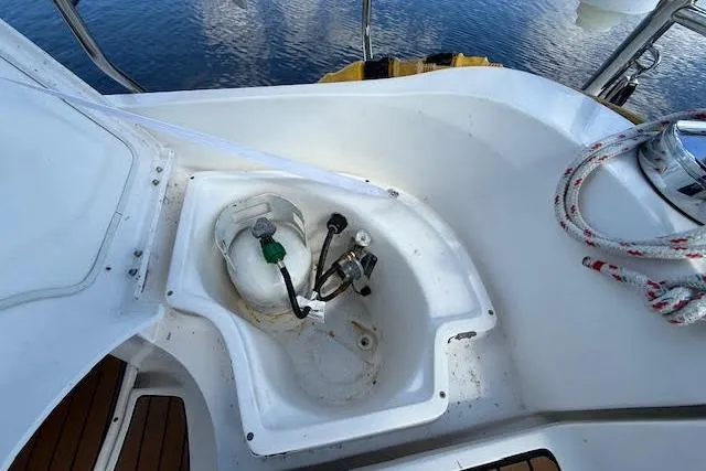 Slide: The Image of Cockpit view of a 2005 Hunter 38 sailboat, featuring a propane tank compartment. - 14