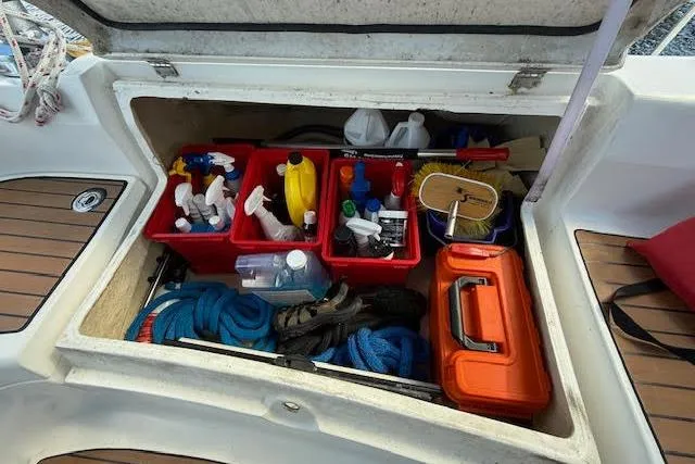Slide: The Image of Storage compartment on a 2005 Hunter 38 sailboat with cleaning supplies and ropes. - 15