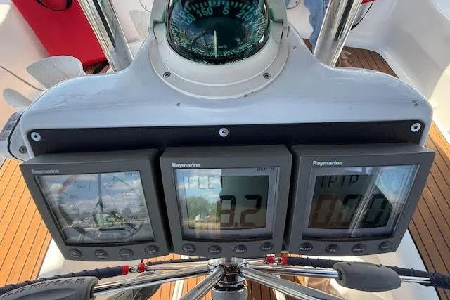 Slide: The Image of Cockpit instruments on a 2005 Hunter 38 sailboat, featuring Raymarine displays and compass. - 16